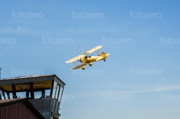 Das Flugzeug Airmen Beans fliegt durch den strahlend blauen Himmel.